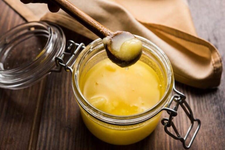 ghee butter in glass jar with wooden spoon e1595913450622